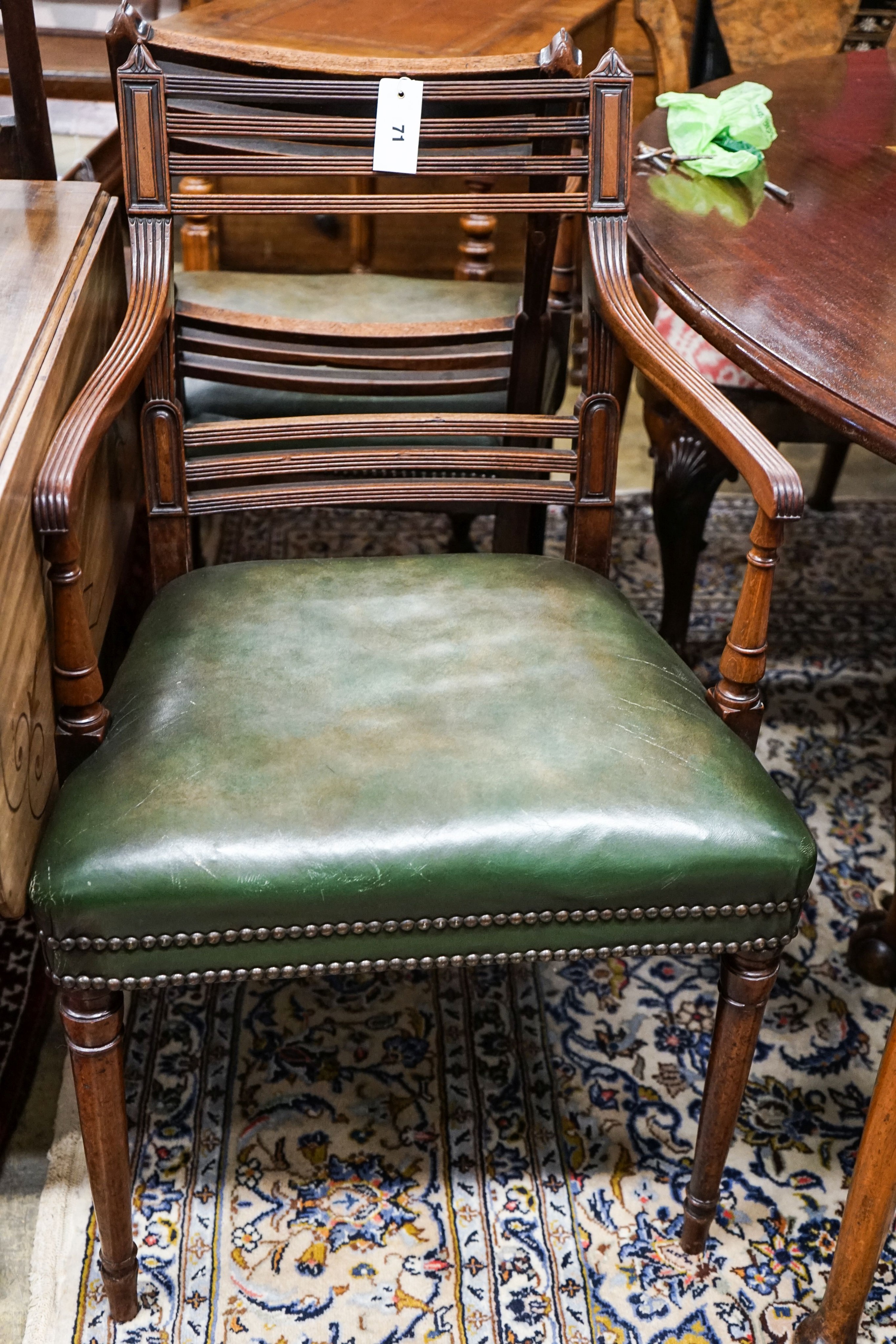 A pair of George III mahogany Sheraton style elbow chairs